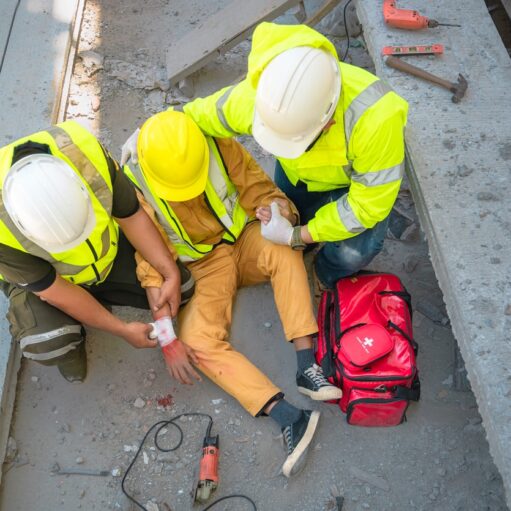 Safety team help a construction worker who has an accident.