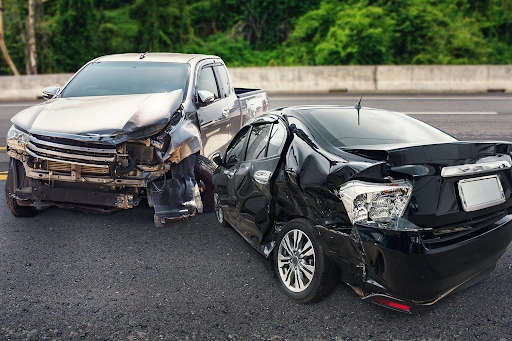 Two severely damaged vehicles after a motor vehicle accident on a California road, representing personal injury cases handled by Appelblatt & Mazzola LLP